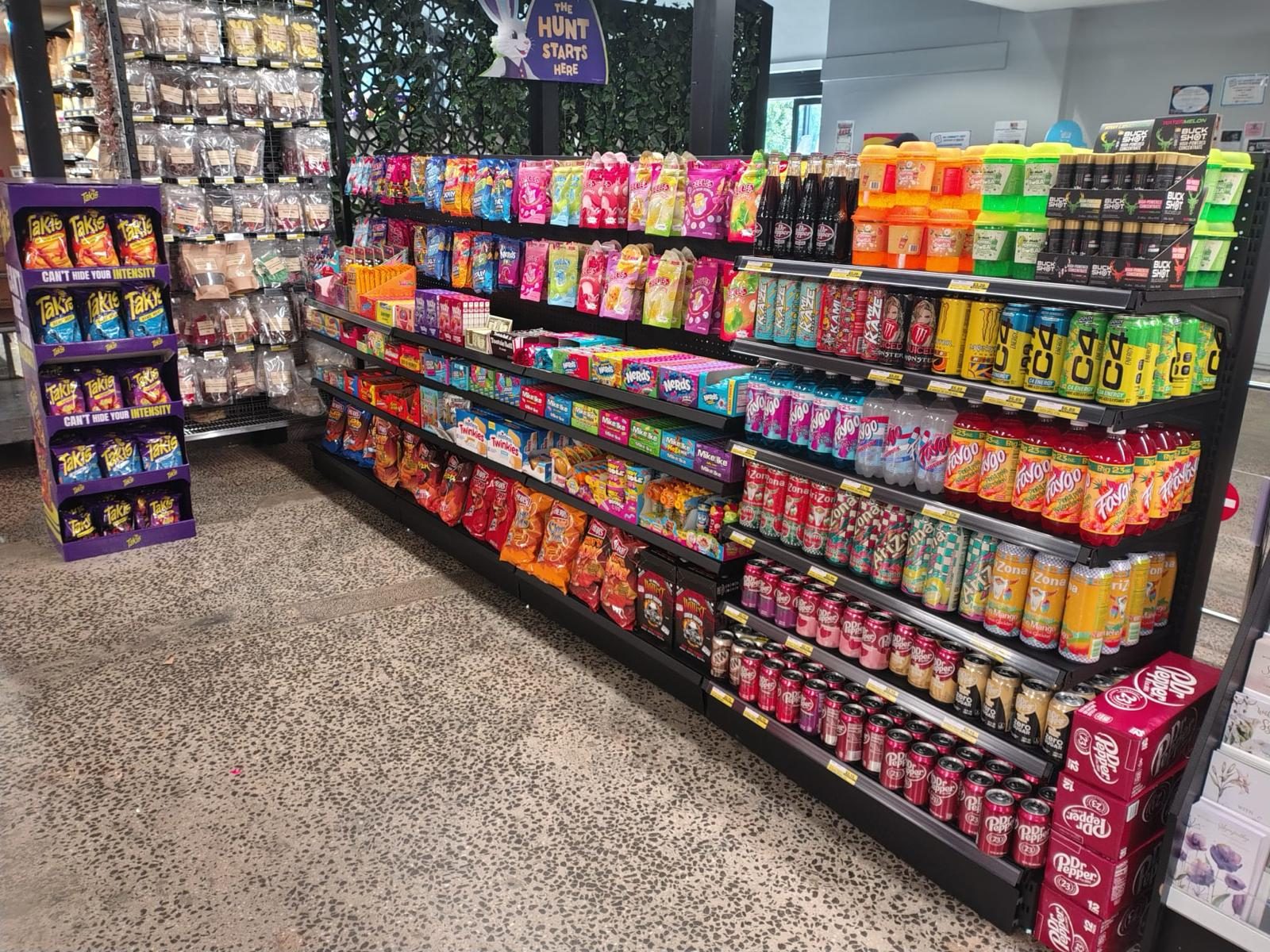 In-store aisle of imported USA drinks, snacks and confectionery on grocery shelving