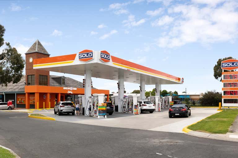 Service station forecourt with fuel canopy and attached convenience store